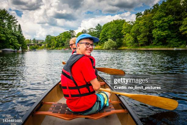 mother and her son are canoeing at fairy lake in huntsville in canada - two people canoeing on a lake stock pictures, royalty-free photos & images