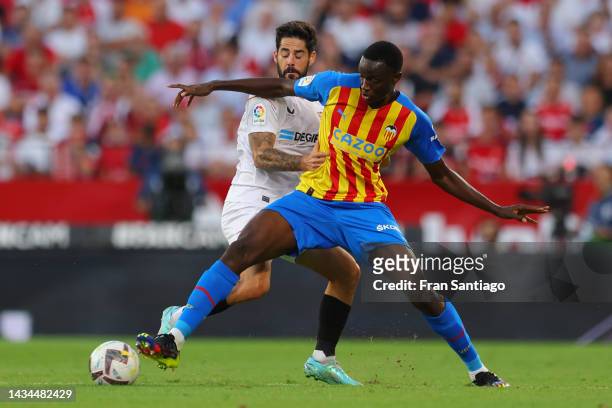 Isco of Sevilla FC battles for possession with Mouctar Diakhaby of Valencia CF during the LaLiga Santander match between Sevilla FC and Valencia CF...