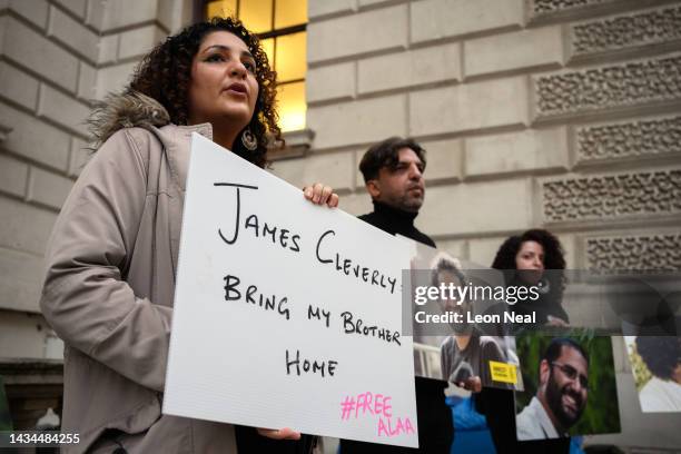 Mona Seif , the sister of Alaa el-Fattah, stands with other supporters as they hold a protest calling for his release at the Foreign & Commonwealth...