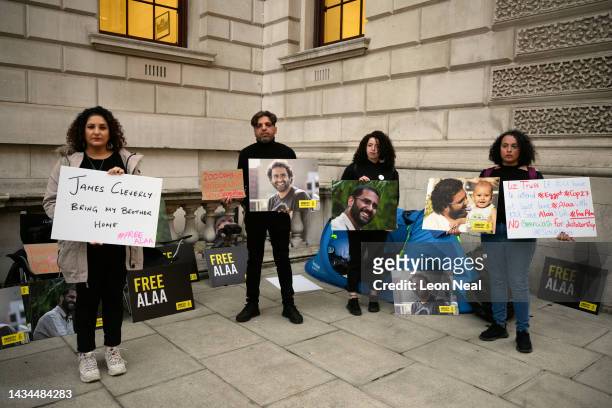 Mona Seif , the sister of Alaa el-Fattah, stands with other supporters as they hold a protest calling for his release at the Foreign & Commonwealth...