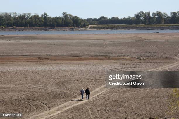 Treasure hunters comb the shoreline of the Mississippi River after it was exposed by low water levels on October 18, 2022 near Portageville,...