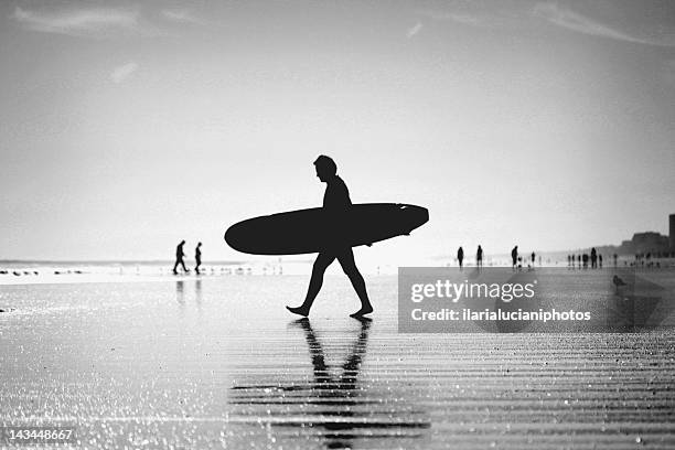 man walking on beach - jacksonville beach stock pictures, royalty-free photos & images