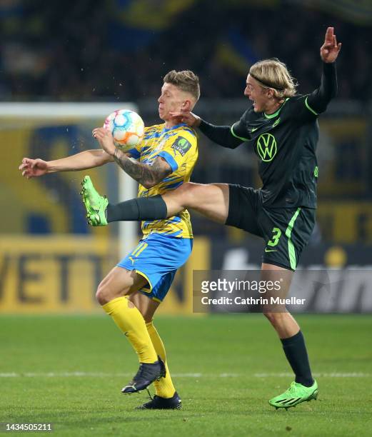 Luc Ihorst of Eintracht Braunschweig battles for possession with Sebastiaan Bornauw of VfL Wolfsburg during the DFB Cup second round match between...
