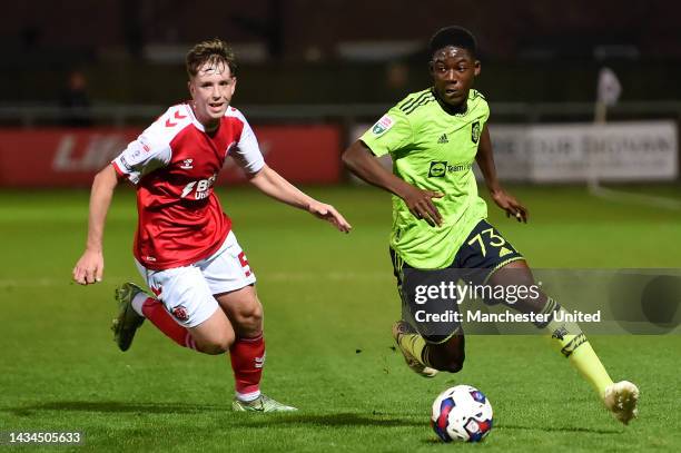 Kobbie Mainoo of Manchester United U21s in action with Sam Glenfield of Fleetwood during the Papa John's Trophy match between Fleetwood and...