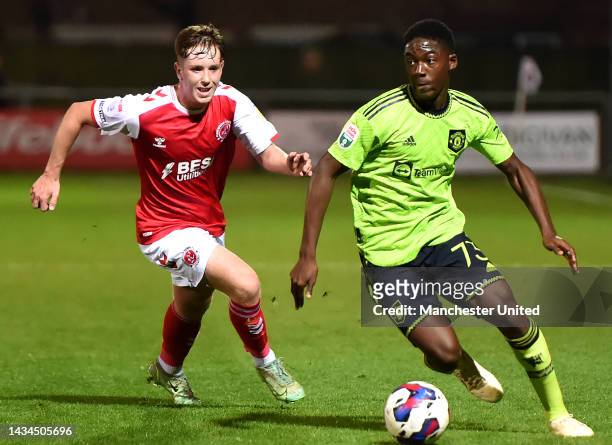 Kobbie Mainoo of Manchester United U21s in action with Sam Glenfield of Fleetwood during the Papa John's Trophy match between Fleetwood and...