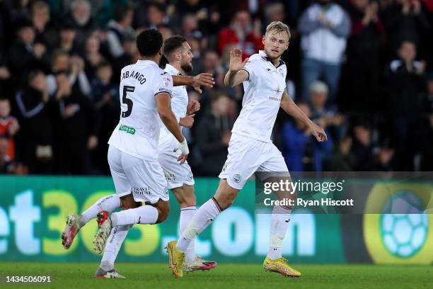 Harry Darling of Swansea City celebrates scoring their side's first goal with teammate Ben Cabango during the Sky Bet Championship between Swansea...