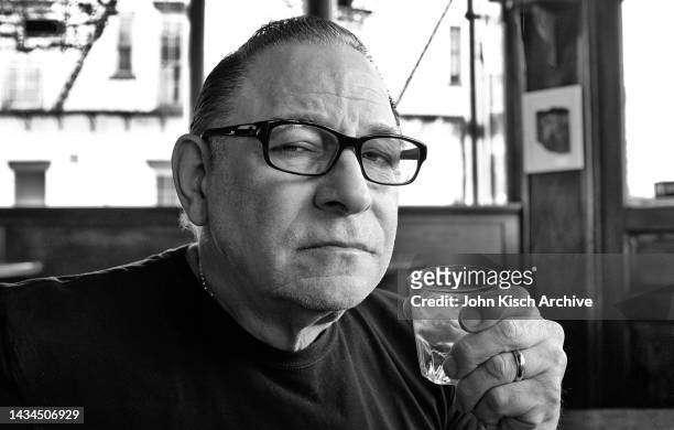 Portrait of American rockabilly singer Robert Gordon drinking whiskey at the White Horse Tavern in New York City, 2016.