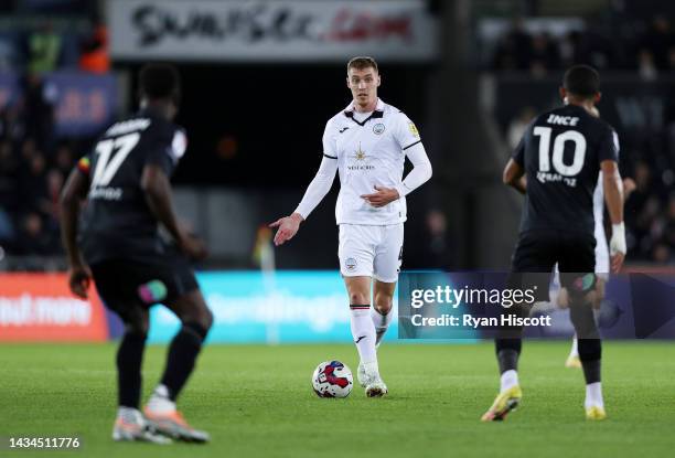 Jay Fulton of Swansea City dribbles with the ball whilst under pressure from Thomas Ince of Reading during the Sky Bet Championship between Swansea...