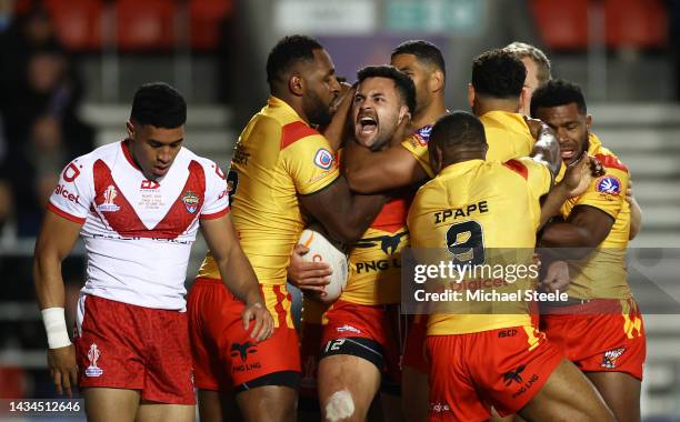 Rhyse Martin of Papua New Guinea celebrates their sides first try with team mates during Rugby League World Cup 2021 Pool D match between Tonga and...