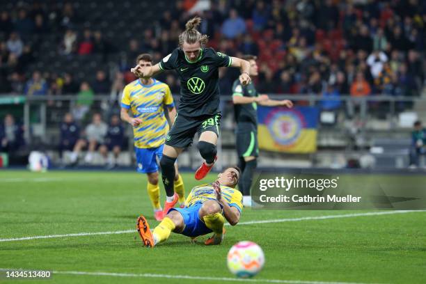 Patrick Wimmer of VfL Wolfsburg battles for possession with Michael Schultz of Eintracht Braunschweig during the DFB Cup second round match between...