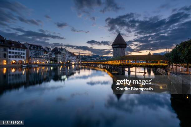 vibrant sunrise over chapel bridge in lucerne, switzerland's downton district and the reuss river - luzern stock pictures, royalty-free photos & images