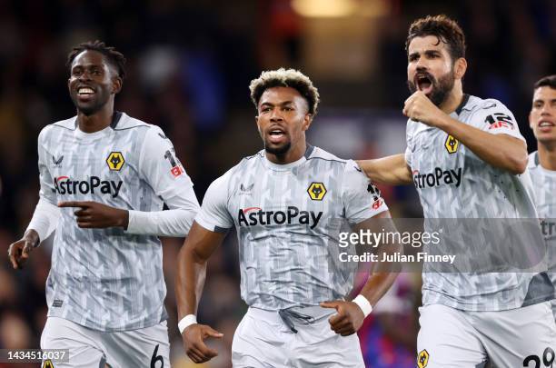 Adama Traore celebrates with Diego Costa of Wolverhampton Wanderers after scoring their team's first goal during the Premier League match between...