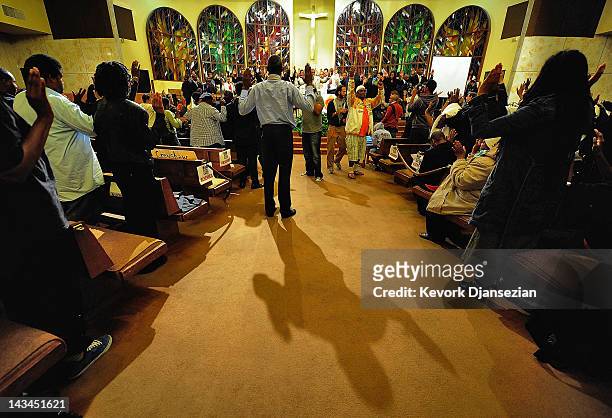 People pray during a rally at West Los Angeles Church in Christ to mark the two-month anniversary of Trayvon Martin's death on April 26, 2012 in Los...