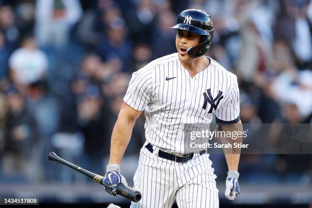 Giancarlo Stanton of the New York Yankees reacts after hitting a three-run home run against the Cleveland Guardians during the first inning in game...