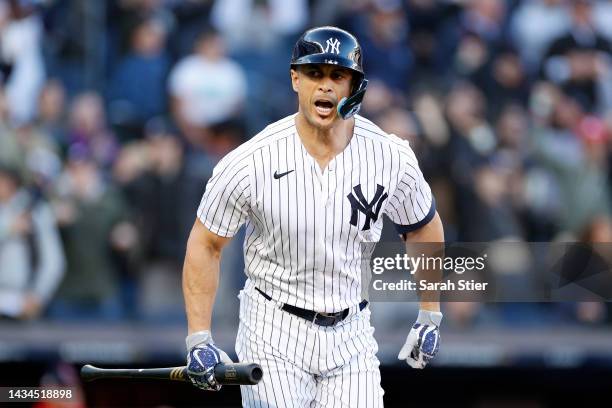 Giancarlo Stanton of the New York Yankees reacts after hitting a three-run home run against the Cleveland Guardians during the first inning in game...