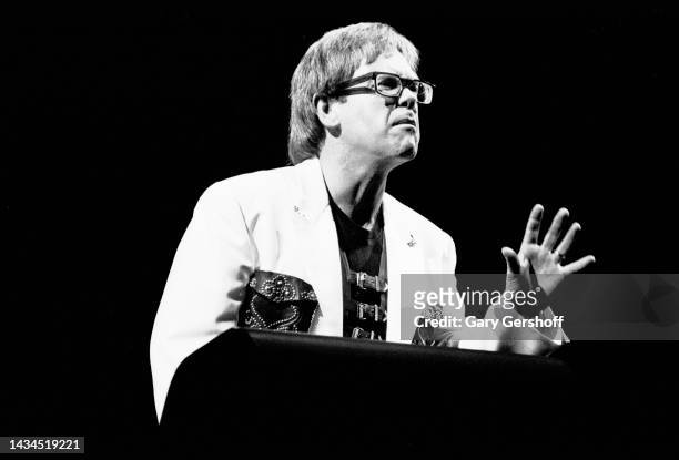 English Rock and Pop musician Elton John plays an electric piano as he performs onstage during 'The One Tour' at Madison Square Garden, New York, New...