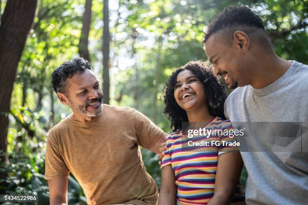 father and daughter playing at a park - lgbtqia culture stock pictures, royalty-free photos & images