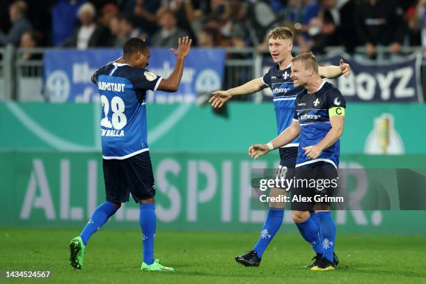 Yassin Ben Balla, Clemens Riedel and Fabian Holland of SV Darmstadt 98 celebrate victory following the DFB Cup second round match between SV...