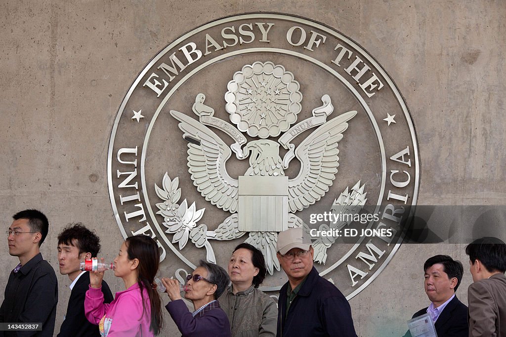 People queue outside the US embassy in B