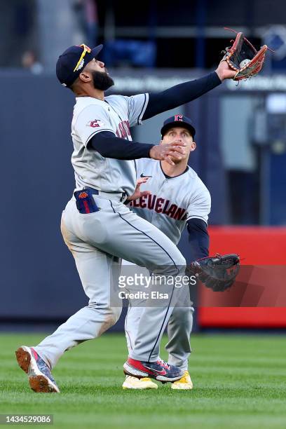 Myles Straw and Amed Rosario of the Cleveland Guardians collide to make a play on a hit by Giancarlo Stanton of the New York Yankees during the third...