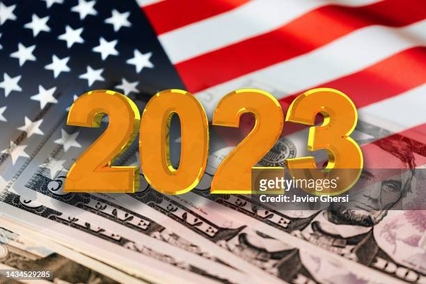 economy graph: year 2023, usa flag and cash dollar bills - deflazione economia foto e immagini stock