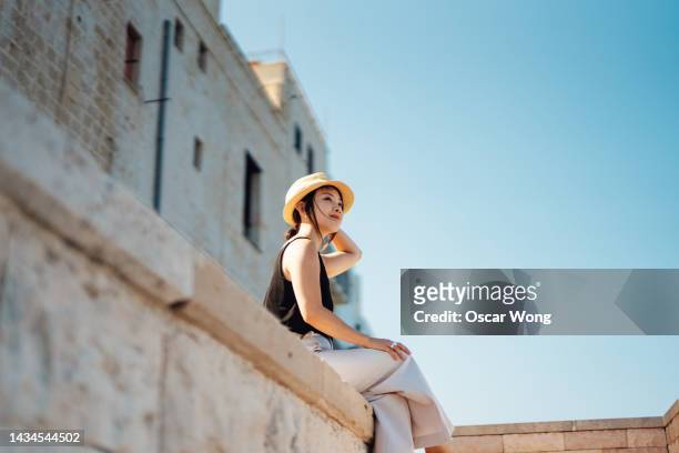 cheerful young asian woman enjoying summer vacations in italy - bari italy stockfoto's en -beelden