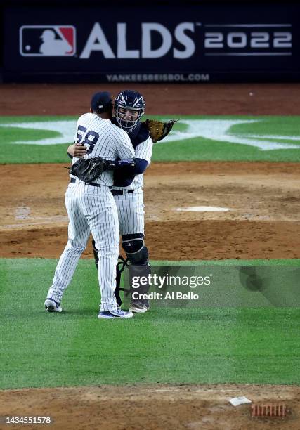 Wandy Peralta and Jose Trevino of the New York Yankees celebrate after defeating the Cleveland Guardians in game five of the American League Division...