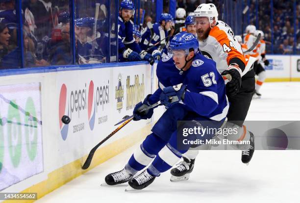 Cal Foote of the Tampa Bay Lightning and Nicolas Deslauriers of the Philadelphia Flyers fight for the puck during a game at Amalie Arena on October...