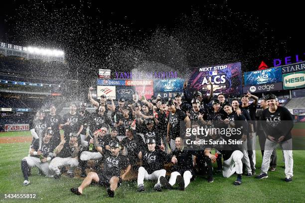 The New York Yankees celebrate on the field after defeating the Cleveland Guardians in game five of the American League Division Series at Yankee...