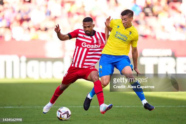 Yangel Herrera of Girona FC is challenged by Ruben Alcaraz of Cadiz CF during the LaLiga Santander match between Girona FC and Cadiz CF at Montilivi...
