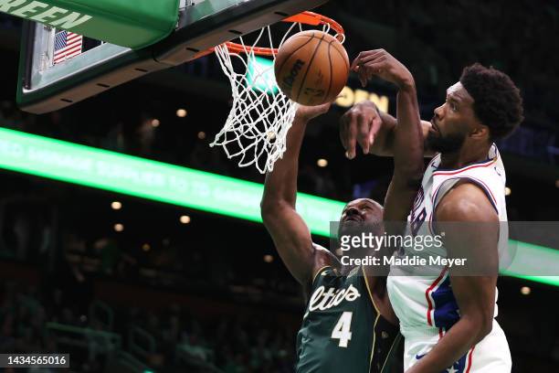 Joel Embiid of the Philadelphia 76ers defends Noah Vonleh of the Boston Celtics during the first half at TD Garden on October 18, 2022 in Boston,...