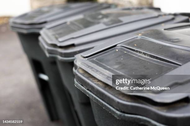 row of residential wheeled trash cans at single family home - public service stock pictures, royalty-free photos & images