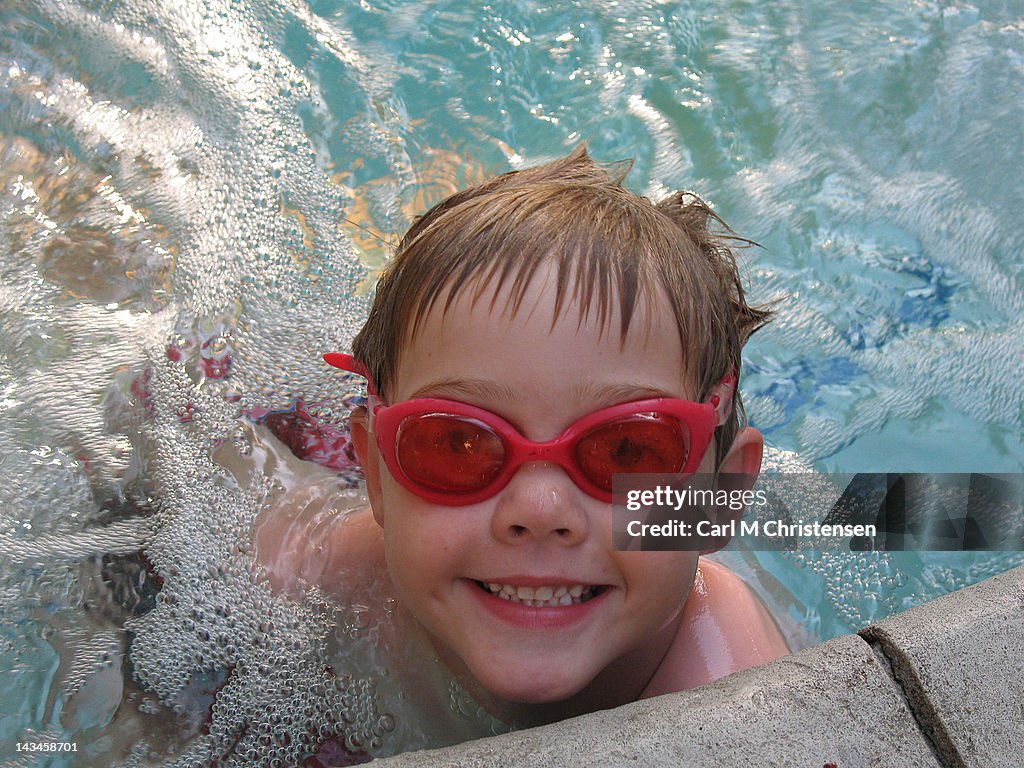 Young boy swimming in pool