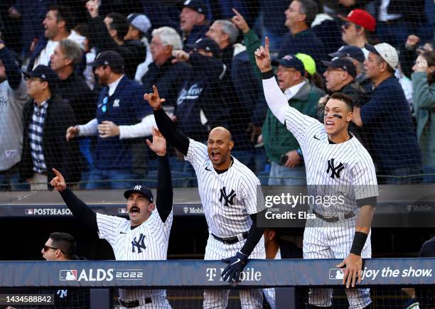 Matt Carpenter, Aaron Hicks and Aaron Judge of the New York Yankees react to Giancarlo Stanton three-run home run against the Cleveland Guardians...