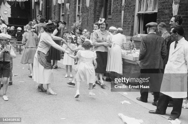 Londoners hold a street party to celebrate the coronation of Queen Elizabeth II, June 1953.