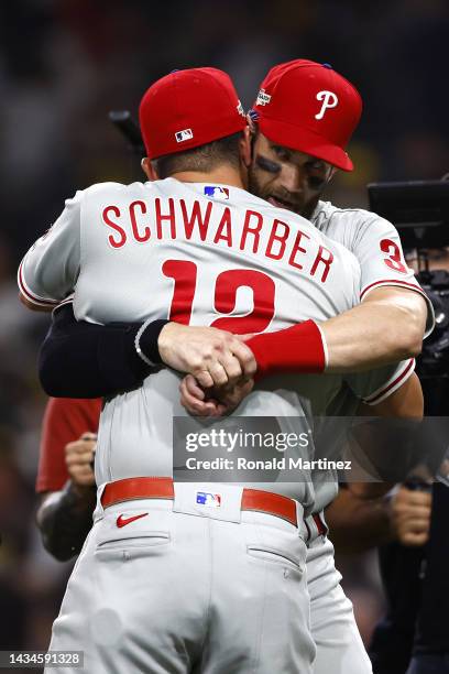 Kyle Schwarber of the Philadelphia Phillies celebrates with Bryce Harper after defeating the San Diego Padres 2-0 in game one of the National League...