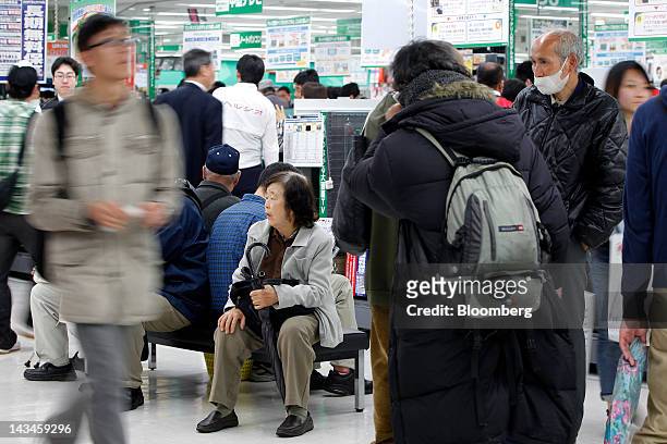 Customers take a rest from their shopping at the newly opened Labi Ofuna electronics store, operated by Yamada Denki Co., in Yokohama City, Kanagawa...
