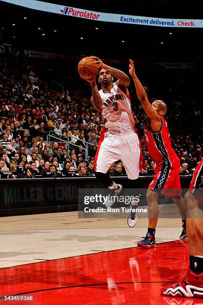 Gary Forbes of the Toronto Raptors shoots against Sundiata Gaines of the New Jersey Nets on April 26, 2012 at the Air Canada Centre in Toronto,...