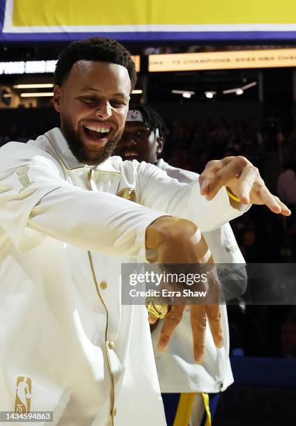 Stephen Curry of the Golden State Warriors shows off his championship ring during a ceremony prior to the game against the Los Angeles Lakers at...