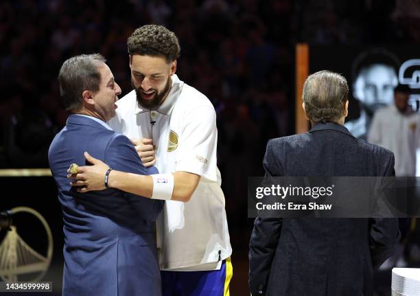 Klay Thompson the Golden State Warriors receives his Championship ring from team owners Joe Lacob and Peter Guber during a ceremony prior to the game...