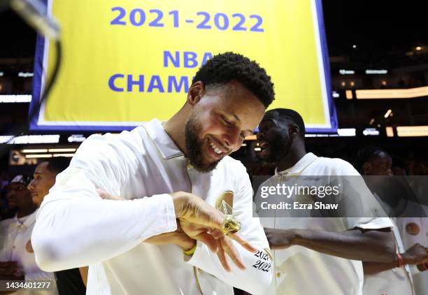 Stephen Curry of the Golden State Warriors inspects his championship ring during a ceremony prior to the game against the Los Angeles Lakers at Chase...
