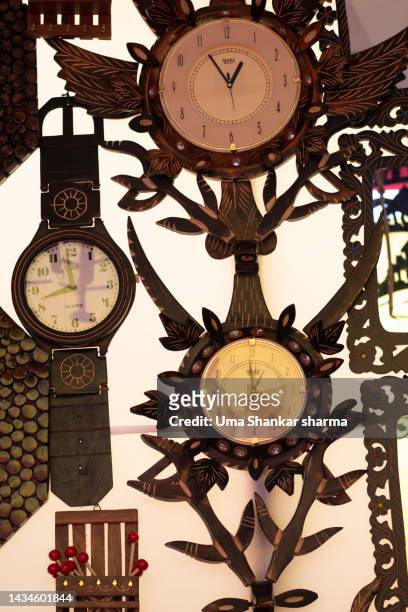antique wooden clocks for sale in a street market. - antique shop stockfoto's en -beelden