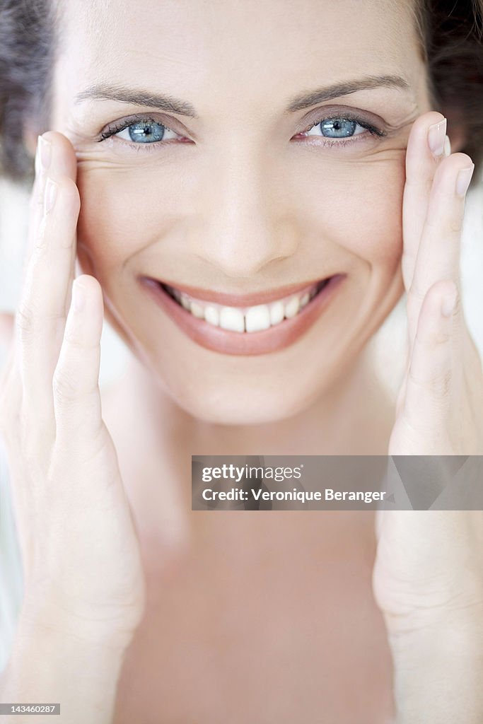 Woman touching her face