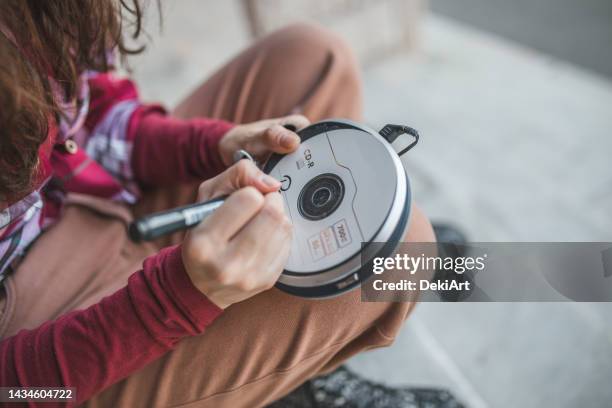 close-up of a woman's hand writing the name of the cd on it - walkman closeup stock pictures, royalty-free photos & images