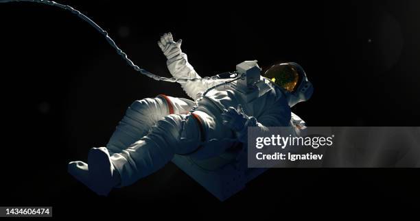 spaceman on a black background hovering in an outer space - astronaut stock pictures, royalty-free photos & images