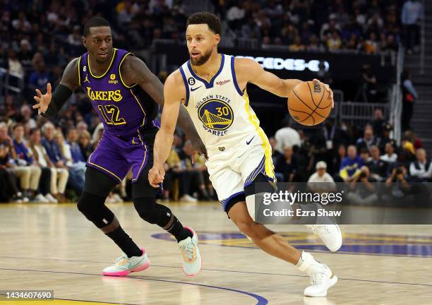 Stephen Curry of the Golden State Warriors controls the ball as Kendrick Nunn of the Los Angeles Lakers defends during the 1st half of the game at...