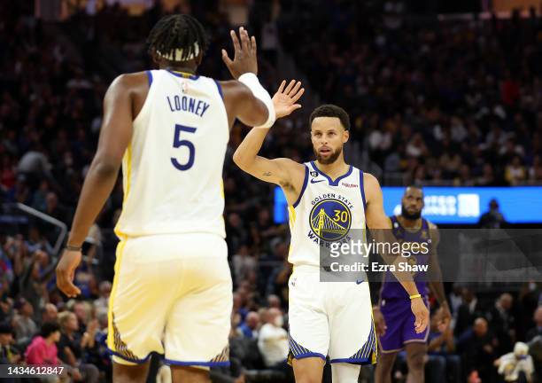 Stephen Curry of the Golden State Warriors high-fives Kevon Looney during the 3rd quarter of the game against Los Angeles Lakers at Chase Center on...