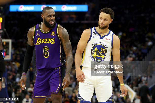 LeBron James of the Los Angeles Lakers speaks to Stephen Curry of the Golden State Warriors during their game at Chase Center on October 18, 2022 in...