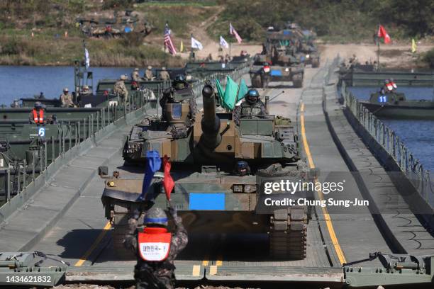 South Korean military's K2 tanks cross a floating bridge set up across the Nam Han River during a river crossing exercise on October 19, 2022 in...