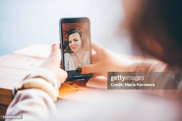 woman making selfie on smartphone in cafe. - telefonnummer wählen stock-fotos und bilder